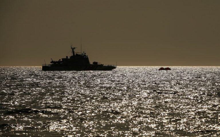 (In this photo from 2020, a Turkish coast guard vessel approaches a life raft with migrants in the Aegean Sea, between Turkey and Greece.  Photo: AP]