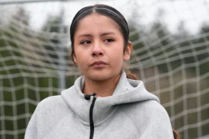 (Valeria Hernandez tears up during an interview at a soccer tournament for immigrant and refugee girls on Sunday, March 29, 2026, in Portland, Ore.  AP Photo: Jenny Kane)