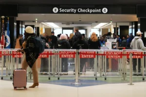 (A traveler walks by a security checkpoint at Seattle-Tacoma International Airport, Nov. 6, 2025, in SeaTac, Wash. (AP Photo/Lindsey Wasson, File)