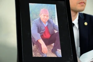 (A photo of Shin Arjun Bahadur, a Nepalese man who died after he was restrained by Japanese police, is shown at a news conference in Tokyo in March 2023. Photo Curtsy: Kyota Tanaka)