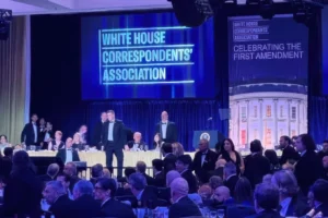 (U.S. Secret Service agents surround President Donald Trump as he is taken from the stage after a shooting incident outside the ballroom during the White House Correspondents Dinner, Saturday, April 25, 2026, in Washington. AP Photo: Alex Brandon)