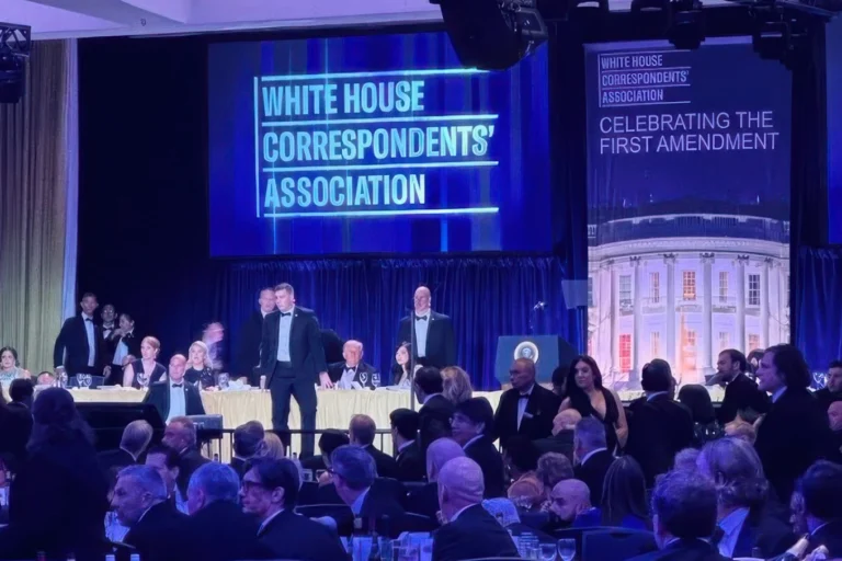 (U.S. Secret Service agents surround President Donald Trump as he is taken from the stage after a shooting incident outside the ballroom during the White House Correspondents Dinner, Saturday, April 25, 2026, in Washington. AP Photo: Alex Brandon)