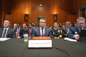 (Acting Under Secretary of Defense and Comptroller Jules Hurst III, Defense Secretary Pete Hegseth and Chairman of the Joint Chiefs of Staff Gen. Dan Caine arrive to testify at a Senate Appropriations subcommittee on defense hearing on the budget request for the Department of Defense, Tuesday, May 12, 2026, in Washington.  AP Photo: Alex Brandon)