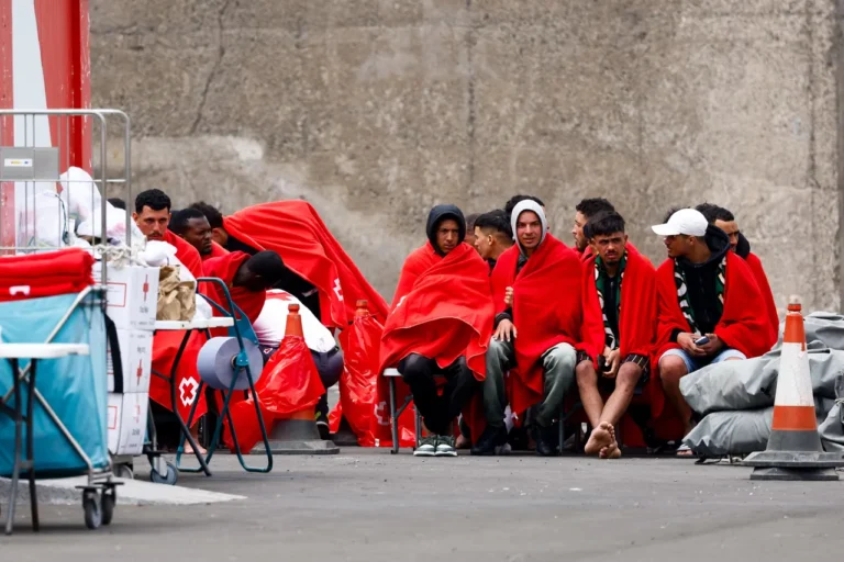 (Migrants wait to be assisted by the Red Cross after disembarking from a Spanish coast guard vessel on an island in Spain, April 4 2026. Photo Curtsy Reuters)