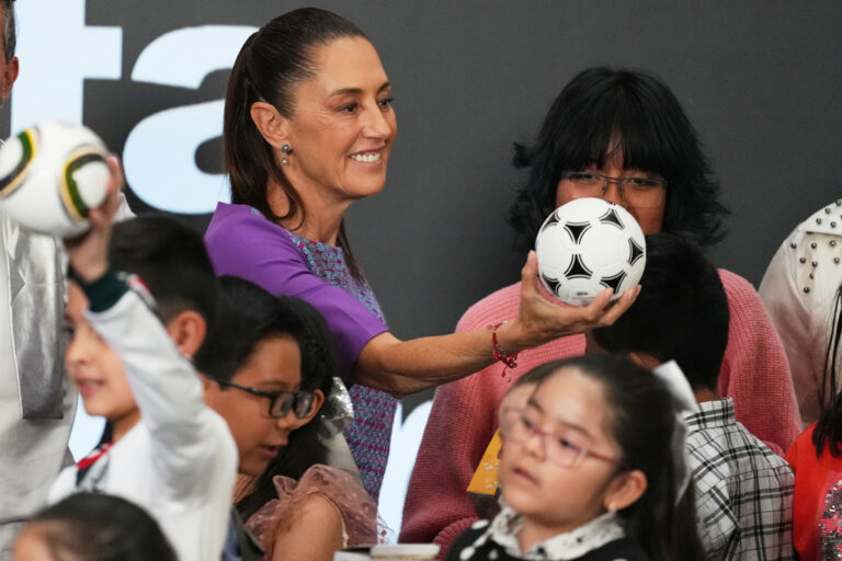 (Mexican President Claudia Sheinbaum gives a soccer ball to children after her daily morning press conference at the National Palace in Mexico City, Thursday, April 30, 2026.  AP Photo: Fernando Llano)