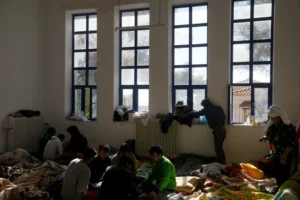 (Migrants, most of them from Afghanistan, rest at an old school used as a temporary shelter on the island of Kythira, southern Greece, Oct. 7, 2022. AP Photo: Thanassis Stavrakis, File)