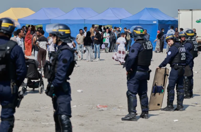 (Police conduct a search operation at a makeshift camp of migrants who want to cross the English Channel to Britain near Dunkirk, northern France, Wednesday, May 27, 2026.  AP Photo: Jean-Francois Badias)
