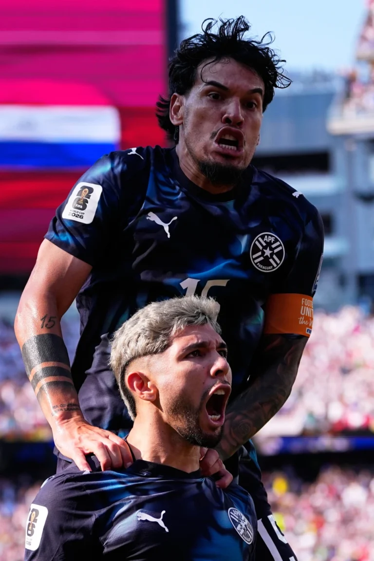 (Paraguay's Julio Enciso (19) celebrates after scoring his side's opening goal with Gustavo Gomez (15), top, during the World Cup round of 32 soccer match between Germany and Paraguay in Foxborough, Mass., near Boston, Monday, June 29, 2026. AP Photo: Petr David Josek)