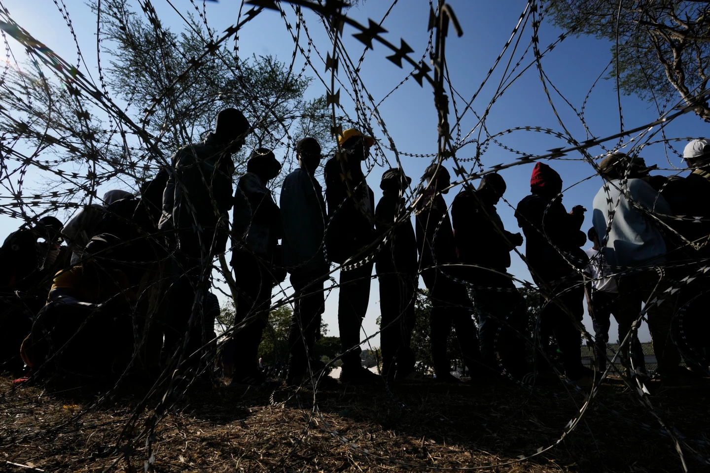 (Malawian migrants stand in a queue for their deportation at a temporary centre, in Durban, South Africa, Thursday, June 18, 2026.  AP Photo: Themba Hadebe)