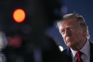 (President Donald Trump talks with reporters before boarding Air Force One at John F. Kennedy International Airport in New York, early Tuesday, June 9, 2026.  AP Photo: Mark Schiefelbein)