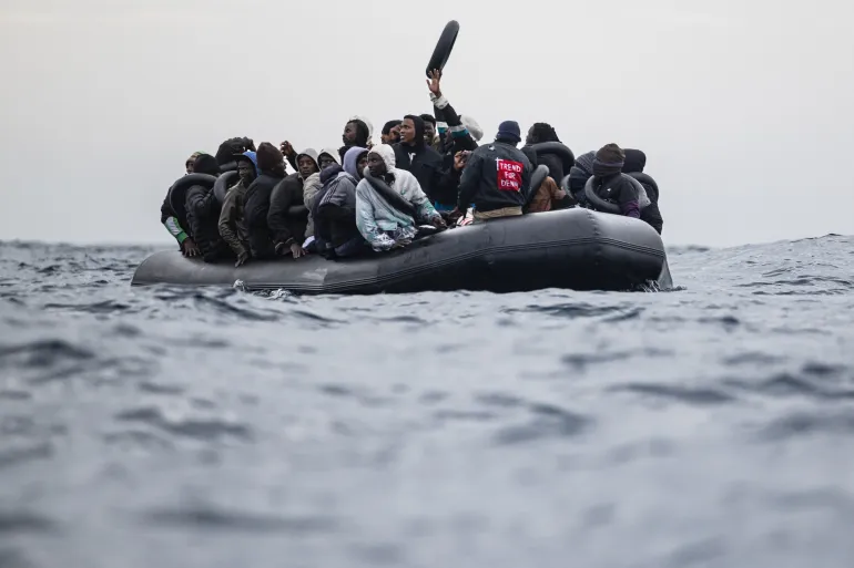 (Migrants onboard a rubber boat wave and gesture as they wait to be rescued by crew members of the Ocean Viking rescue ship in the search-and-rescue zone in the Mediterranean Sea near the Libyan coast, on January 16, 2026. Photo: AFP)