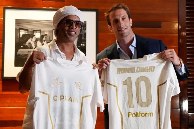 (Ronaldinho holds up his new jersey for Ravenna. AP Photo: Rebecca Blackwell)