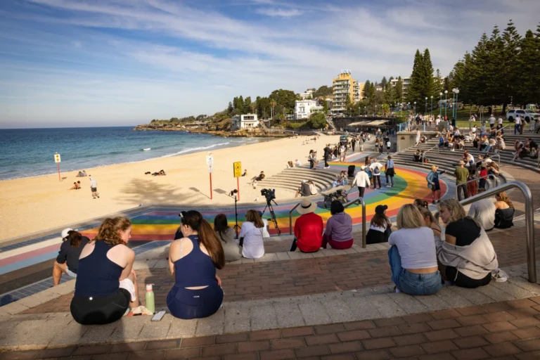 (People sit on stairs at Coogee beach following a shark attack in Sydney, Saturday, June 13, 2026. (Nadir Kinani/AAP Image via AP))