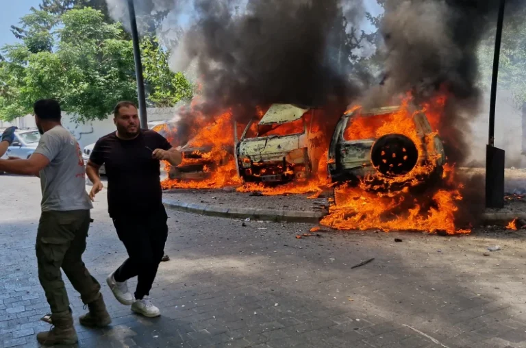 (A man runs past burning cars following an Israeli airstrike in the southern port city of Sidon, Lebanon, Wednesday, June 10, 2026. (AP Photo: Mohammed Zaatari)