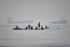 (People gather on paddleboards in shallow water as cargo and service vessels are anchored in the Strait of Hormuz off Bandar Abbas, Iran, Monday, June 1, 2026. Photo: Amirhosein Khorgooi-ISNA via AP)