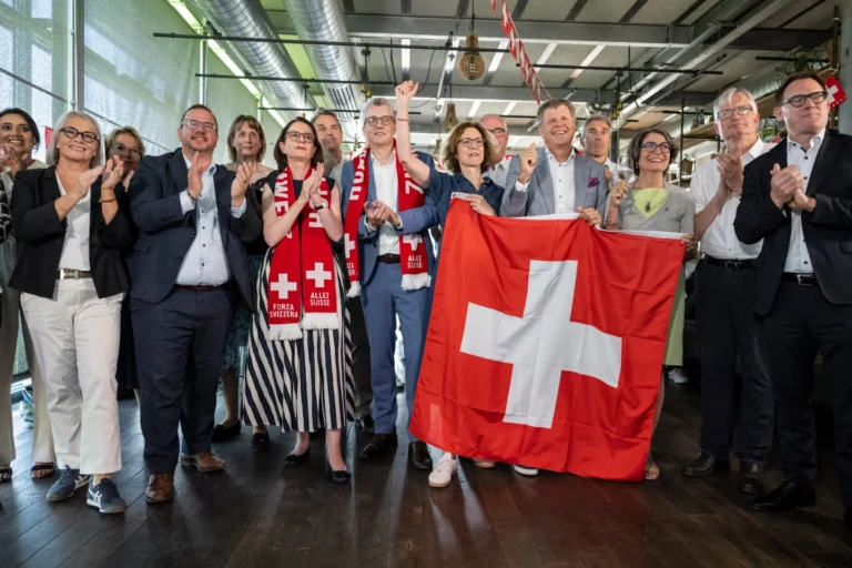(Members of the Federal Parliament and other representatives of civic organizations, celebrate during a get together of a cross-party alliance against the SVP's popular initiative "No 10-Million Switzerland" which the people and the cantons voted on this election Sunday, June 14, 2026, in Bern, Switzerland. (AP Photo: Alessandro della Valle.)