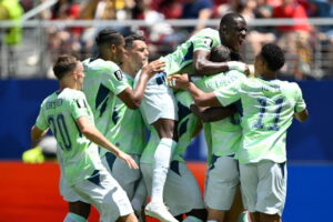 (Switzerland's Breel Embolo is mobbed by teammates after scoring the opening goal from the penalty spot during the World Cup Group B soccer match between Qatar and Switzerland in Santa Clara, Calif., near San Francisco, Saturday, June 13, 2026. AP Photo: Eakin Howard)