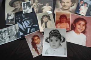 (Childhood photos of a woman adopted as a toddler by an American war veteran, who he found in the 1970s in an Iranian orphanage and raised as a Christian, are displayed along with a picture of her father, a WWII Air Force veteran, at left, and additional family photos, Monday, June 24, 2024, in Henderson, Nev. (AP Photo: David Goldman, File)