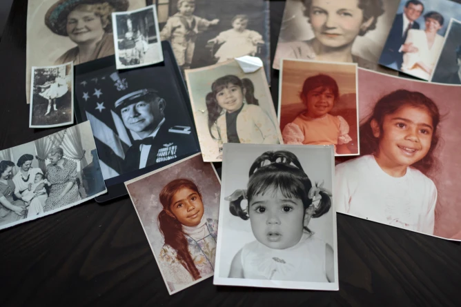 (Childhood photos of a woman adopted as a toddler by an American war veteran, who he found in the 1970s in an Iranian orphanage and raised as a Christian, are displayed along with a picture of her father, a WWII Air Force veteran, at left, and additional family photos, Monday, June 24, 2024, in Henderson, Nev. (AP Photo: David Goldman, File)