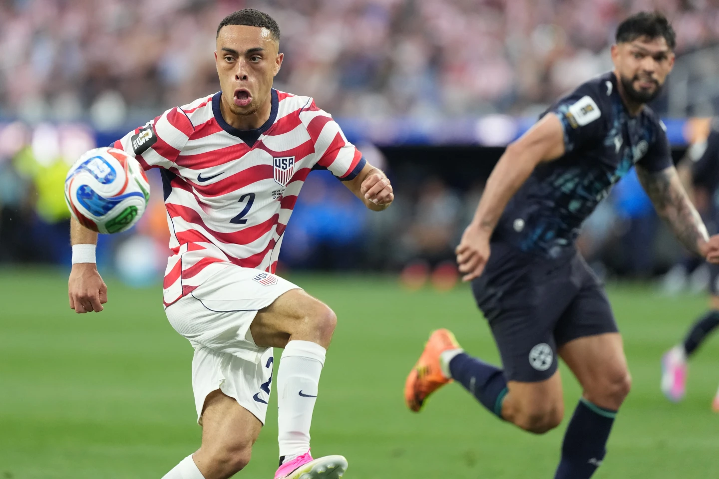 (United States' Sergino Dest, left, controls a ball next to Paraguay's Omar Alderete during the World Cup Group D soccer match in Inglewood, Calif., near Los Angeles, Friday, June 12, 2026.  AP Photo: Jae C. Hong)