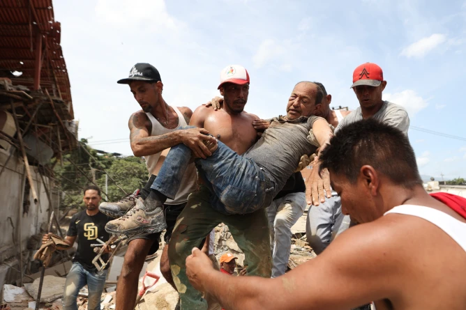 (Back-to-back powerful earthquakes slammed Venezuela on Wednesday evening, collapsing buildings in the capital of Caracas and leaving residents shaken. (AP Photo: Juan Arraez & Andry Rincon)