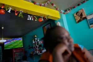 (Vivianne Petit Frere Looks on below a "viva Mexico" sign at her Haitian food restaurant Lakou Lakay, June 27, 2026 in Trijuna Mexico. AP Photo: Gregory Bull)