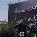 (A billboard depicting U.S. President Donald Trump lying on what appears to be a coffin and bearing anti-Trump messages, including the phrase “We Kill Trump,” is seen at Islamic Revolution Square in downtown Tehran, Iran, Wednesday, July 15, 2026.  AP Photo: Vahid Salemi)