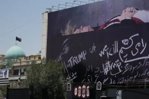 (A billboard depicting U.S. President Donald Trump lying on what appears to be a coffin and bearing anti-Trump messages, including the phrase “We Kill Trump,” is seen at Islamic Revolution Square in downtown Tehran, Iran, Wednesday, July 15, 2026.  AP Photo: Vahid Salemi)