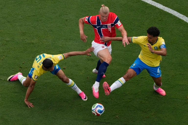 (Norway’s Erling Haaland (9) battles for the ball with Brazil’s Douglas Santos (16) and Marquinhos (4) during the World Cup round of 16 soccer match between Brazil and Norway in East Rutherford, N.J., near New York, Sunday, July 5, 2026.  AP Photo: Matt Slocum)