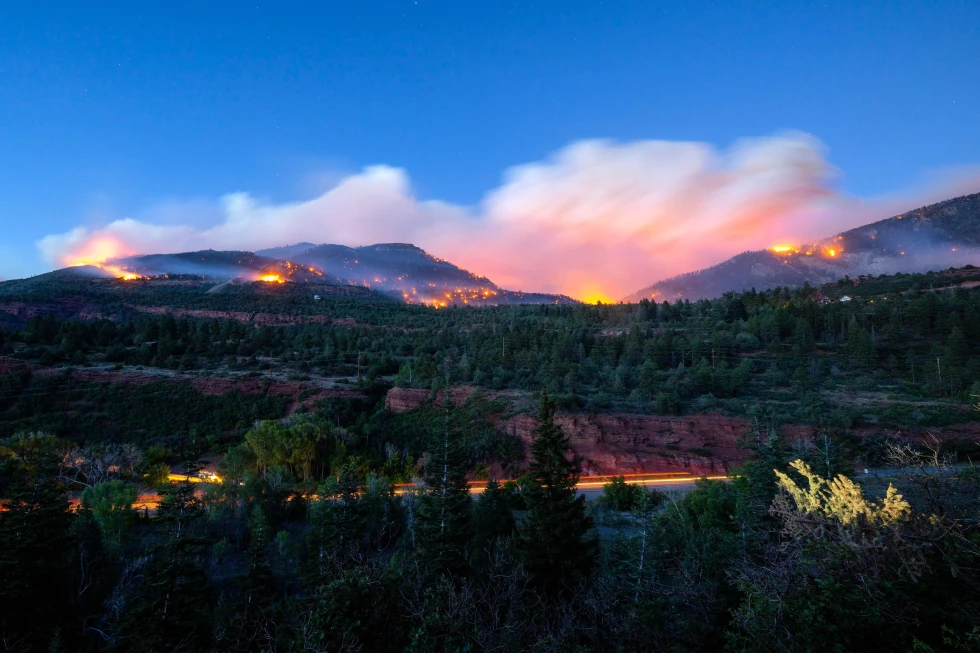 (Firefighters drive along Highway 550 as they try to access the Gold Mountain Fire on the town line of Ouray and Ridgeway, Colo., on Sunday, June 28, 2026. Photo: Michael Seamans-The Gazette via AP)