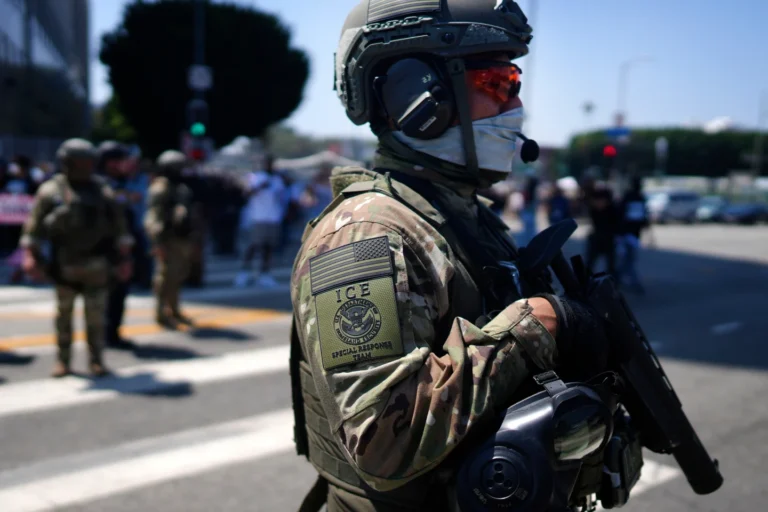 (An ICE Special Response Team member stands guard outside the Metropolitan Detention Center, while protesters gather outside to denounce the ICE, U.S. Immigration and Customs Enforcement, operations, June 10, 2025, in downtown Los Angeles.  AP File Photo: Eric Thayer)
