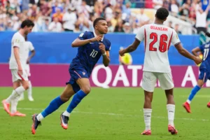 (France's Kylian Mbappe (10) celebrates scoring his side's third goal as England's Jarell Quansah (26) reacts to the score during the World Cup third-place playoff soccer match between France and England in Miami Gardens, Fla., Saturday, July 18, 2026.  AP Photo: Rebecca Blackwell)