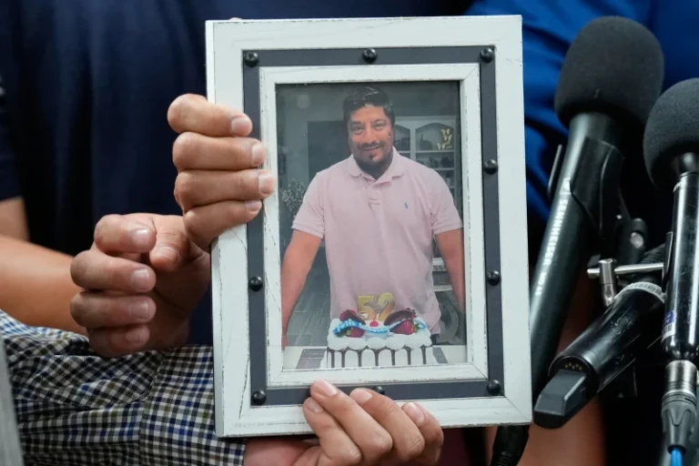 (Ronaldo Salgado and Lorenzo Jr., sons of Lorenzo Salgado Araujo, hold a photograph of their father during a news conference Wednesday, July 8, 2026, in Houston. AP Photo: David J. Phillip)