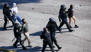 (Los Angeles, California, June 8, 2025: Los Angeles Police Department officers escorting four handcuffed individuals who were protesting against ICE. File photo courtesy: Dantemortem-Shutterstock)