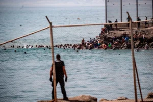 (Migrants cross from Morocco into the Spanish enclave of Ceuta, Thursday, July 30, 2026. AP Photo: Antonio Sempere)