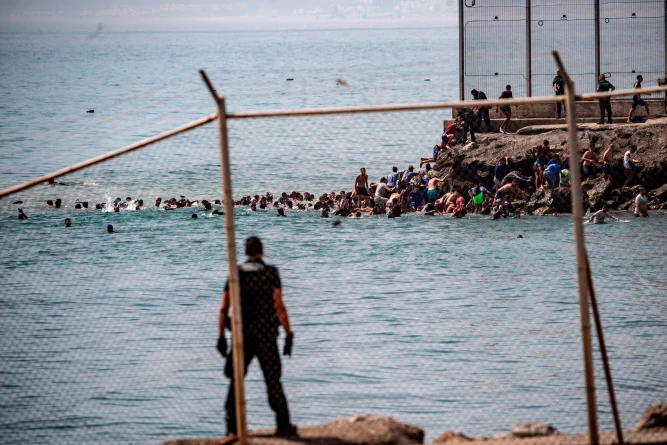 (Migrants cross from Morocco into the Spanish enclave of Ceuta, Thursday, July 30, 2026. AP Photo: Antonio Sempere)