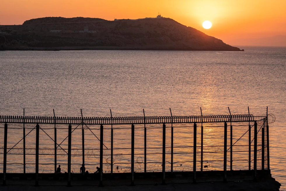 (Moroccan men fish on the Moroccan side of the border with Spain, as seen from the district of Benzu in the Spanish enclave of Ceuta, June 3, 2021. AP File Photo: Bernat Armangue)