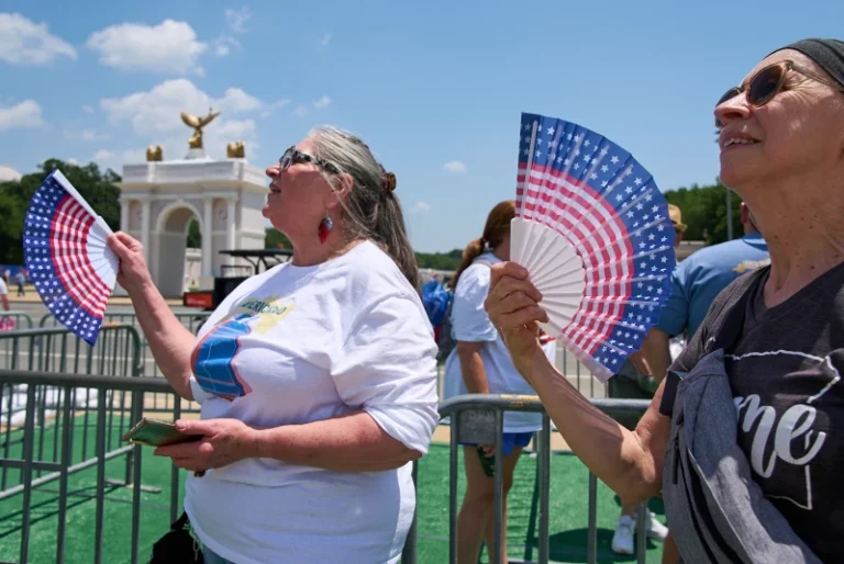 ( Mickelina Papotto, of Salem, Ore., left, and Lorie Odegaard, of Gaithersburg, Md., fan themselves while waiting in line for the ferris wheel at the Great American State Fair on the National Mall, July 1, 2026, in Washington.  AP Photo: Jacquelyn Martin)