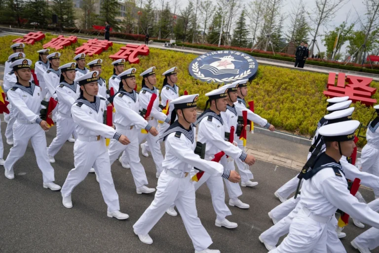 (Sailors march past the insignia for the People’s Liberation Army (PLA)'s naval submarine academy during a tour arranged for foreign journalists a day before the opening of the West Pacific Naval Symposium in Qingdao in eastern China’s Shandong province, Sunday, April 21, 2024. (AP File Photo: Ng Han Guan)
