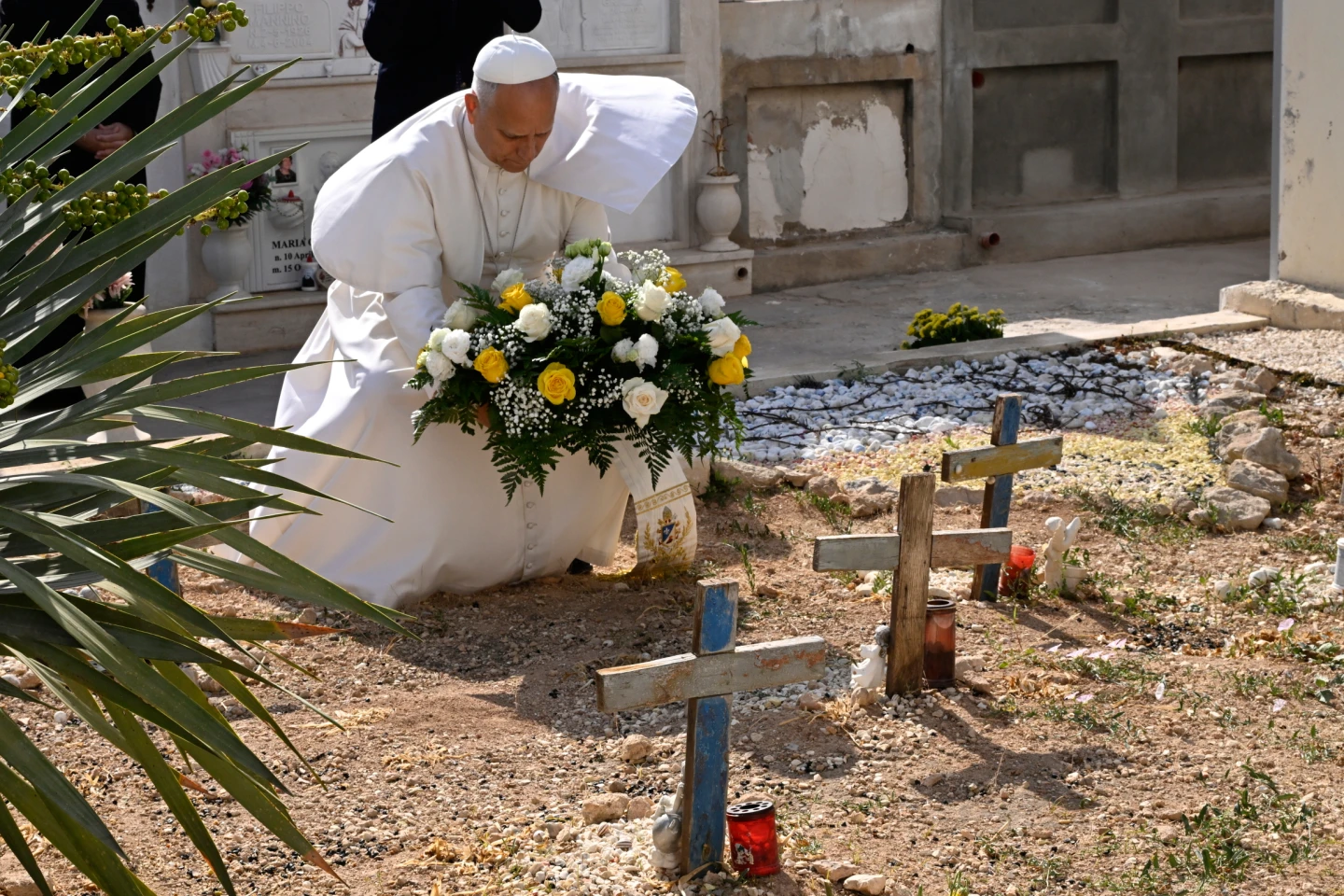 (Pope Leo XIV pays tribute at the cemetery and on little Joussef’s grave, in Lampedusa, Sicily, southern Italy, Saturday, July 4, 2026, during a one-day pastoral visit to an island that has become a symbol of the risks faced by migrants trying to reach Europe by sea. Pool Photo: Ciro Fusco, Via AP)
