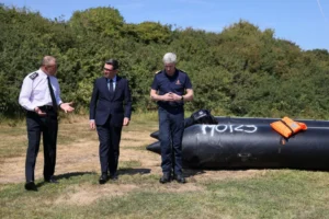 (Britain’s Prime Minister Andy Burnham, centre, speaks with John Craig, Interim Chief Coastguard, and Duncan Capps, Border Security Commander (DG BSC), left, near a recovered small boat, which was used by migrants crossing the English Channel, during a visit to HM Coastguard Maritime Rescue Coordination Centre, in Dover, Britain, Aug. 2, 2026. Photo: Jack Taylor-Pool Photo via AP)