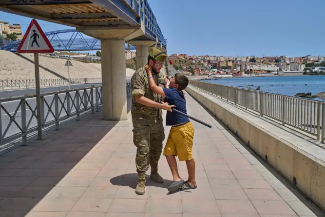 (A 12-year-old unaccompanied minor who crossed into Spain is escorted by a Spanish soldier to the Spain-Morocco border as the child begs not to be sent back to Morocco from the Spanish enclave of Ceuta, Monday, Aug. 3, 2026. The forced deportation of the unaccompanied minor was stopped by a high-ranking official a few yards before the child reached the border after residents and journalists said the migrant was a minor. AP Photo: Bernat Armangue)