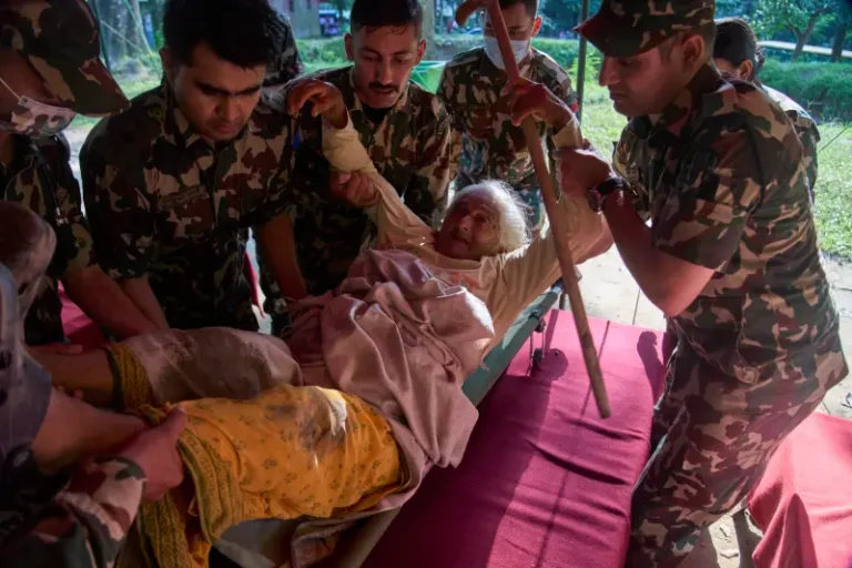 (An elderly survivor is taken to a makeshift hospital for treatment at the army’s Maithali barracks after being rescued from flash flooding in Nuwakot district, Nepal, Thursday, Aug. 27, 2026. (AP Photo/Niranjan Shrestha)