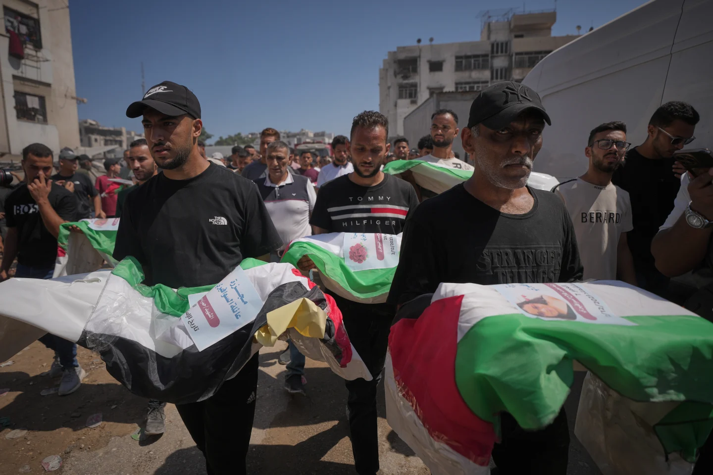 (Mourners carry the flag-draped bodies of Palestinians killed in Israeli strikes during the war with Hamas, whose remains were recently recovered from the rubble, in Gaza City, Thursday, Aug. 20, 2026.  AP Photo: Jehad Alshrafi)