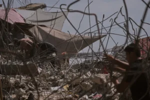 (Palestinians remove iron from the rubble of buildings destroyed by Israeli airstrikes during the war with Hamas, repair and recycle it for construction, building tents or selling it, in Gaza City, Sunday, Aug. 16, 2026. AP Photo: Jehad Alshrafi)