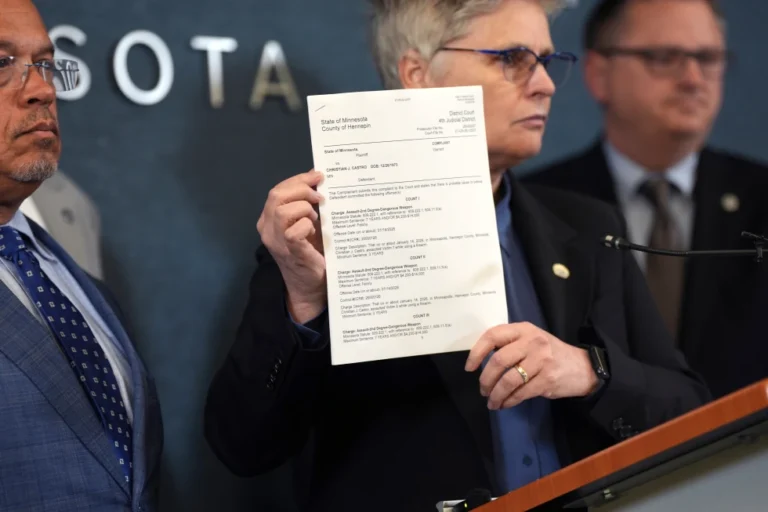 (Hennepin County attorney Mary Moriarty holds up a document containing charges against ICE agent Christian Castro during a news conference at the Hennepin County Government Center in Minneapolis, on Monday, May 18, 2026. (Renée Jones Schneider/Minnesota Star Tribune via AP,File)