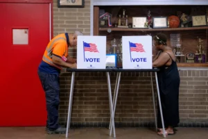 (People vote in the primary election at Northwestern High School in Detroit, Tuesday. AP Photo: Nic Antaya)