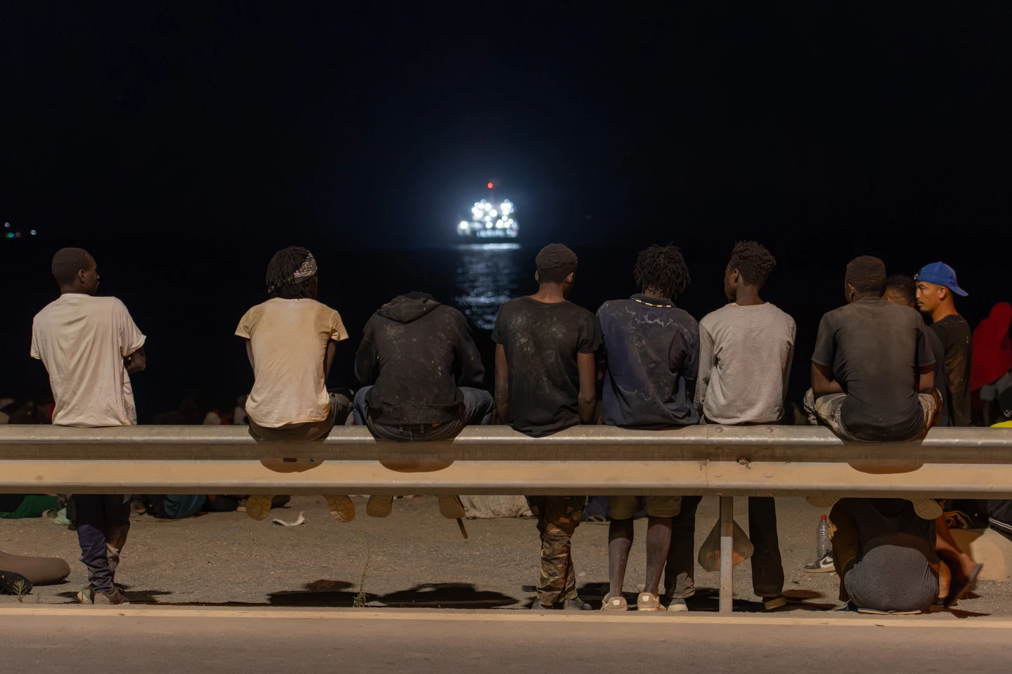(Migrants who crossed into Spain from Morocco gather on a beach in the Spanish enclave of Ceuta, Sunday, Aug. 2, 2026. AP Photo: Antonio Sempere)