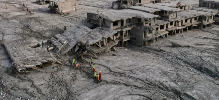 (A drone view shows rescue workers inspect the area and damaged structures following recent flash flooding along the Trishuli River in the Devighat area of Nuwakot district, Nepal, Saturday, Aug. 29, 2026. AP Photo: Rajesh Kumar Singh)