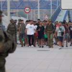 (Escorted by the Spanish army, migrants who crossed into Spain return to Morocco from the Spanish enclave of Ceuta on Aug. 1, 2026.  AP Photo: Antonio Sempere)